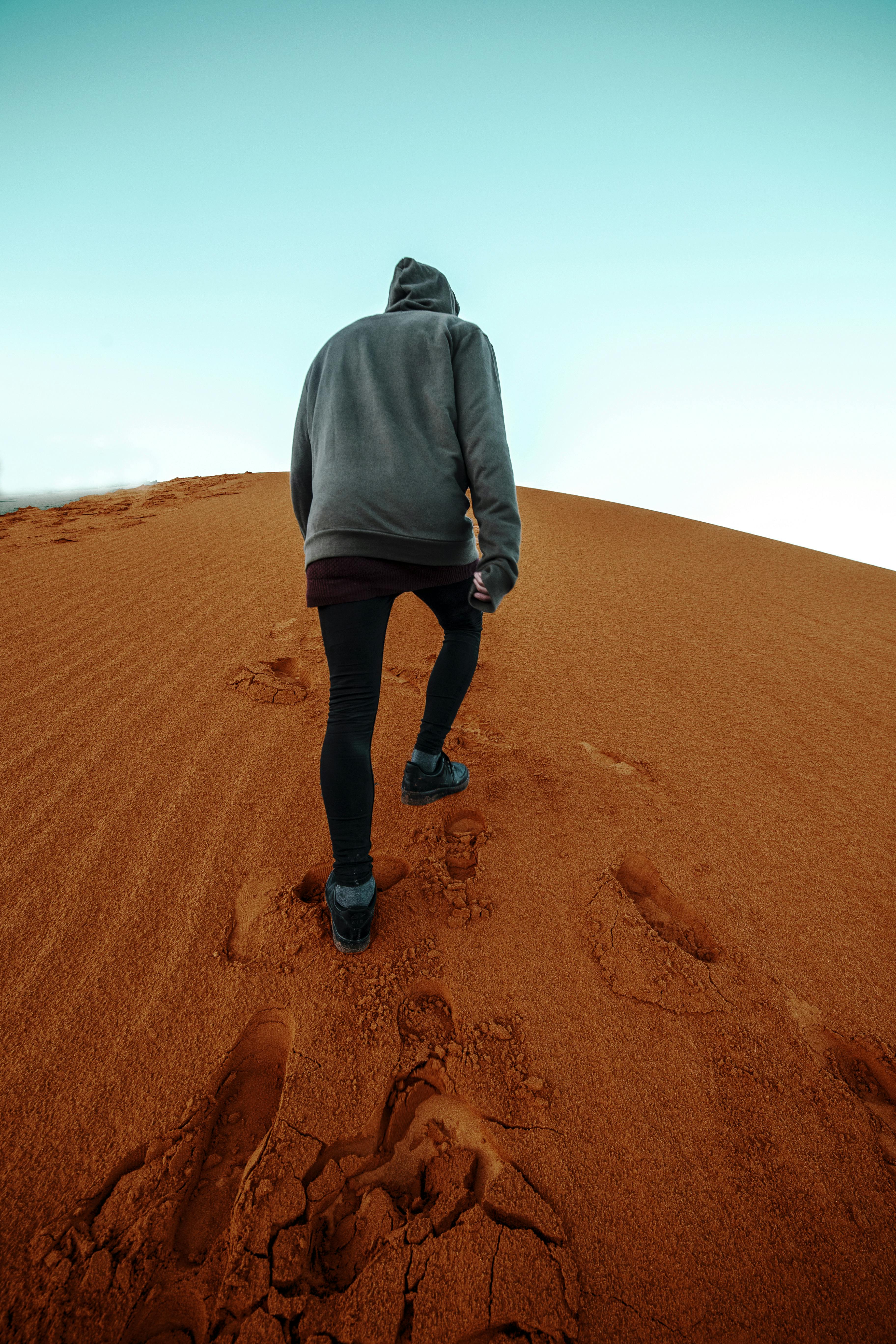 Walking uphill on sand dune